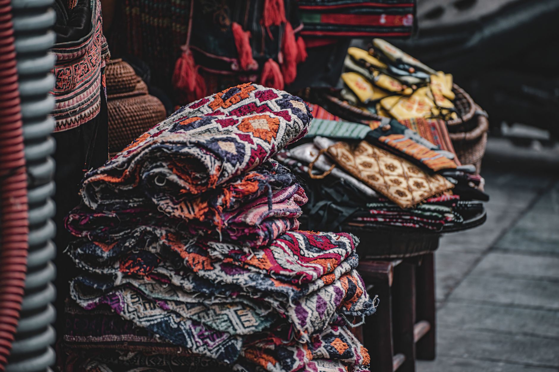 Songket and batik textiles glowing at a night bazaar stall